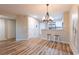 Well-lit open concept room including dining and kitchen area, with bar stool seating and wood-look flooring at 1100 Possum Trot Rd. # H234, North Myrtle Beach, SC 29582