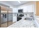 Modern kitchen features stainless steel appliances and white cabinets at 1100 Possum Trot Rd. # H234, North Myrtle Beach, SC 29582