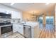 Bright kitchen features white cabinets, stainless appliances, and granite countertops at 1100 Possum Trot Rd. # H234, North Myrtle Beach, SC 29582