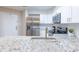 Bright kitchen featuring stainless steel appliances, granite countertops, white cabinets and subway tile backsplash at 1100 Possum Trot Rd. # H234, North Myrtle Beach, SC 29582
