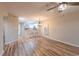 Bright living room featuring wood flooring with views into the kitchen/dining area with 2 stools at the breakfast bar at 1100 Possum Trot Rd. # H234, North Myrtle Beach, SC 29582