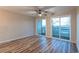 Bright living room with wood floors and large sliding glass doors leading to the balcony and providing views at 1100 Possum Trot Rd. # H234, North Myrtle Beach, SC 29582