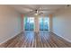 Bright living room with sliding glass doors leading to a private balcony overlooking the neighborhood at 1100 Possum Trot Rd. # H234, North Myrtle Beach, SC 29582