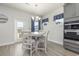 Kitchen dining area with white table, four chairs, and access to backyard at 1204 Passante Ave., Myrtle Beach, SC 29572