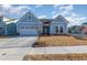 Newly built home with light blue siding, two-car garage, and well-maintained lawn at 1204 Passante Ave., Myrtle Beach, SC 29572