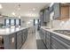 Modern kitchen with gray cabinets, quartz countertops, and stainless steel appliances at 1204 Passante Ave., Myrtle Beach, SC 29572