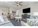 Open living room featuring hardwood floors, cozy seating arrangement, and large TV at 1204 Passante Ave., Myrtle Beach, SC 29572