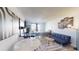 Open-concept living and bedroom area with neutral tones, a sofa, and a bed at 1207 S Ocean Blvd. # 50707, Myrtle Beach, SC 29577