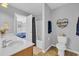 Bright bathroom with double sinks, modern fixtures, and decorative shelving, providing a clean and inviting space at 1213 Pineridge St., Conway, SC 29527