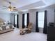 The main bedroom features multiple windows, a tray ceiling, ceiling fan, and sitting area at 1213 Pineridge St., Conway, SC 29527
