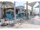 Pool deck with lounge chairs and umbrellas at 1300 Crested Iris Way, North Myrtle Beach, SC 29582