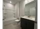 Clean bathroom with a shower-tub combo, modern vanity, and ample lighting at 1305 Crested Iris Way, North Myrtle Beach, SC 29582