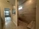 Stylish bathroom showcasing a walk-in shower with horizontal tiling and a built-in bench, complemented by sleek fixtures at 1305 Crested Iris Way, North Myrtle Beach, SC 29582