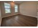 Bright bedroom featuring hardwood floors and large windows that provide ample natural light at 1305 Crested Iris Way, North Myrtle Beach, SC 29582