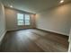 Cozy bedroom featuring wood flooring, recessed lighting, and a bright window view creating a relaxing atmosphere at 1305 Crested Iris Way, North Myrtle Beach, SC 29582