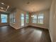 Inviting dining area with hardwood floors, chandelier lighting, and large windows providing ample natural light at 1305 Crested Iris Way, North Myrtle Beach, SC 29582
