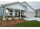 Charming home with white siding, a brick-accented porch, and a well-manicured lawn, inviting curb appeal at 1305 Crested Iris Way, North Myrtle Beach, SC 29582