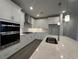 Bright kitchen with stainless steel appliances, white cabinets, a marble countertop island, and pendant lighting at 1305 Crested Iris Way, North Myrtle Beach, SC 29582
