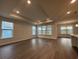 Spacious living room with wood flooring, recessed lighting, and large windows offering plenty of natural light at 1305 Crested Iris Way, North Myrtle Beach, SC 29582
