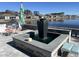 Picturesque backyard with a modern water fountain, patio seating, grill, and scenic lake view at 1310 Beautyberry Way, North Myrtle Beach, SC 29582
