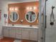 Elegant bathroom features double sinks, modern lighting, and a tiled walk-in shower at 1310 Beautyberry Way, North Myrtle Beach, SC 29582