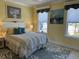 Cozy bedroom featuring a queen bed, two windows and soft yellow walls, creating a serene and welcoming atmosphere at 1310 Beautyberry Way, North Myrtle Beach, SC 29582
