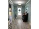 Charming entryway featuring light blue walls, a vintage dresser, and a decorative wreath on the front door at 1310 Beautyberry Way, North Myrtle Beach, SC 29582
