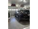 Spacious two car garage with a modern black SUV and organized overhead storage at 1310 Beautyberry Way, North Myrtle Beach, SC 29582