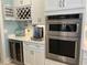 Gourmet kitchen features stainless steel appliances, wine rack, and sleek white cabinetry at 1310 Beautyberry Way, North Myrtle Beach, SC 29582