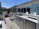 An outdoor kitchen and dining space with stainless steel appliances that offers picturesque waterfront views at 1310 Beautyberry Way, North Myrtle Beach, SC 29582