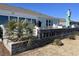 Beautiful patio with outdoor kitchen, waterfront views, and well-maintained landscape and hardscape at 1310 Beautyberry Way, North Myrtle Beach, SC 29582