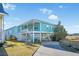 Charming light teal exterior with a spacious elevated deck at 147 Anglers Dr., Murrells Inlet, SC 29576