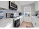Bright kitchen with white cabinets, marble countertops, and stainless steel appliances at 147 Anglers Dr., Murrells Inlet, SC 29576