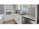Modern kitchen featuring white shaker cabinets, marble countertops, and stainless steel sink at 147 Anglers Dr., Murrells Inlet, SC 29576