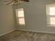 Bedroom with carpet, two windows, and ceiling fan at 148 Junco Circle, Longs, SC 29568
