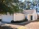 Tan house with two-car garage and landscaping at 148 Junco Circle, Longs, SC 29568