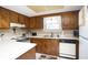 Galley kitchen features wood cabinets and white countertop at 1807 C Hillside Dr., North Myrtle Beach, SC 29582