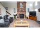 Living room features a brick fireplace and large TV at 1807 C Hillside Dr., North Myrtle Beach, SC 29582