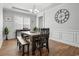 Formal dining room with wood table, bench seating, and large clock at 1945 La Playa Dr., Myrtle Beach, SC 29588