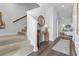 Bright entryway with carpeted stairs, wood floors, and a stylish console table at 253 Sandridgebury Dr. # 59, Little River, SC 29566