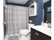 Clean bathroom with dark vanity, shower curtain, and decorative accents at 265 Encore Circle, Myrtle Beach, SC 29579