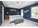 Primary bedroom with king-size bed, gray bench, and large windows at 265 Encore Circle, Myrtle Beach, SC 29579