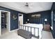 Primary bedroom with king-size bed, gray bench, and access to closet at 265 Encore Circle, Myrtle Beach, SC 29579