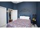 Bedroom with floral bedding, dark walls, and decorative wall art at 265 Encore Circle, Myrtle Beach, SC 29579