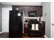 Modern kitchen with dark cabinetry, black appliances, and granite countertops at 265 Encore Circle, Myrtle Beach, SC 29579