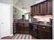 Well-equipped kitchen with dark wood cabinets and granite countertops at 265 Encore Circle, Myrtle Beach, SC 29579