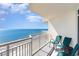 Balcony with seating overlooking the ocean and beach below on a sunny day at 2701 S Ocean Blvd. # 1711, North Myrtle Beach, SC 29582