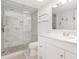 Elegant bathroom with white vanity, toilet, and shower featuring river rock floor and marble tile surround at 2701 S Ocean Blvd. # 1711, North Myrtle Beach, SC 29582