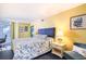 Comfortable bedroom with floral comforter, accent chair, and bright walls at 2701 S Ocean Blvd. # 1711, North Myrtle Beach, SC 29582