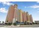 Multi-story building showcasing balconies and multiple condos on a partly cloudy day near the ocean at 2701 S Ocean Blvd. # 1711, North Myrtle Beach, SC 29582